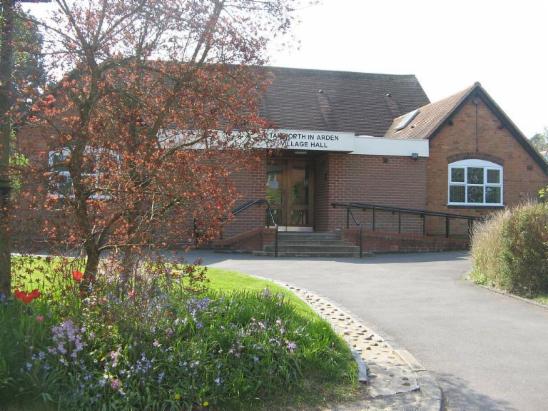 A photograph of the front of Tanworth Village hall, also showing ramp access