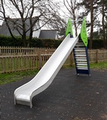 childrens slide, silver metal slide with green steps 
